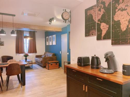 a kitchen and living room with a table and a world map on the wall at Lisloft Appartement à 5 Min du ZooParc de Beauval, Centre ville Saint-Aignan in Saint-Aignan