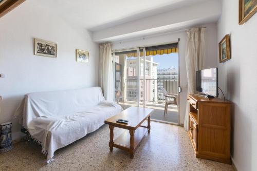 a living room with a bed and a tv at Oratge in Playa de Gandia