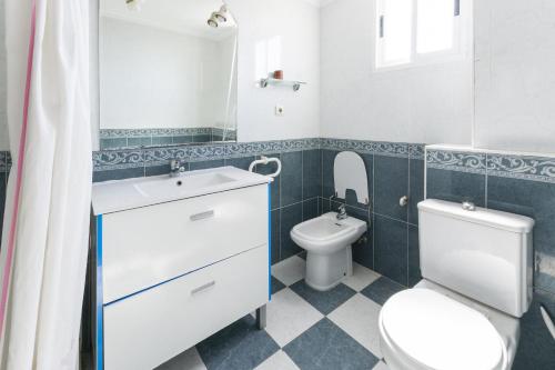 a bathroom with a toilet and a sink at Oratge in Playa de Gandia
