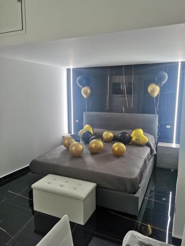 a bedroom with a bed with balloons on it at La casetta di gra in Palermo