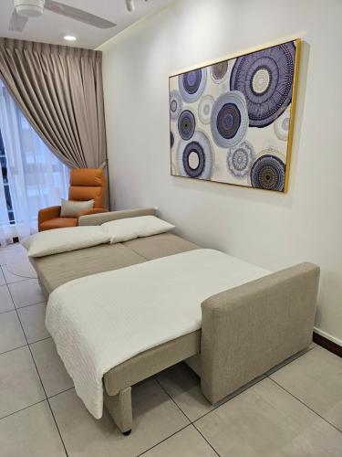 two beds in a room with a painting on the wall at W Residence 6 Near Airport in Donggongon