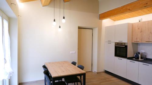 a kitchen and dining room with a wooden table at La Casetta in Petriolo