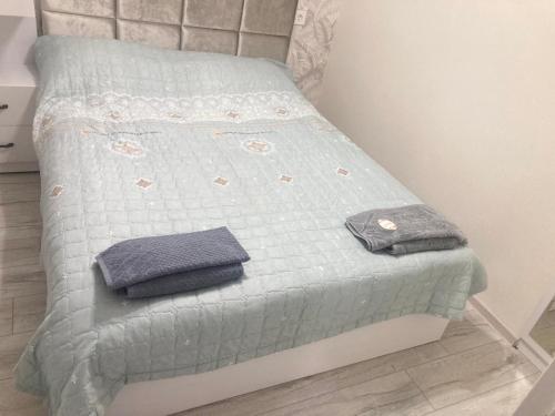 a bed with two pillows on it in a room at AZERBAYCAN in Sumqayyt
