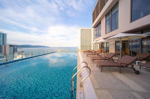 een zwembad aan de zijkant van een gebouw bij Green Beach Nha Trang in Nha Trang