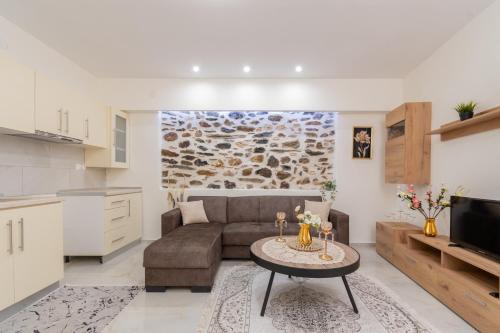 a living room with a couch and a table at Paradise House in Neos Marmaras