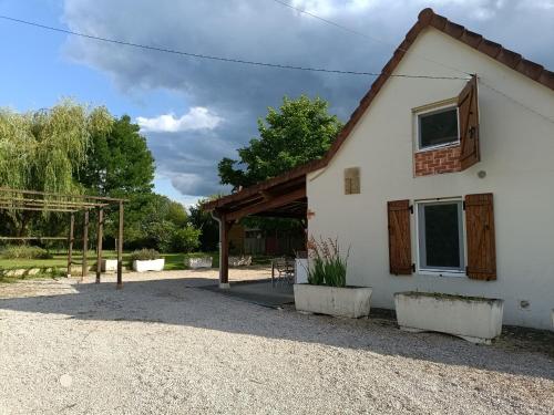 a white house with a gambrel roof at Maison Bressanne in Sornay