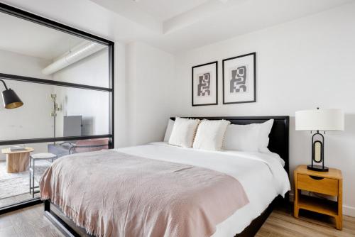 a white bedroom with a large bed and a window at SoMa 1br w concierge bbq ac nr I-80 SFO-1434 in San Francisco