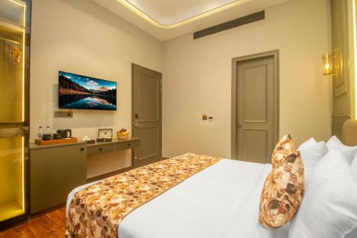 a hotel room with a bed and a television at Amritara Maa Katra in Katra