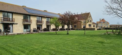 a house with solar panels on the front yard at Hotel Westendia and Free Parking Top Breakfast in Middelkerke