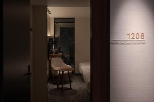 a room with a table and a chair in a room at Premier hotel -CABIN PRESIDENT- Tokyo in Tokyo