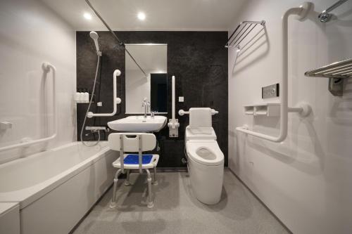a white bathroom with a sink and a toilet at Premier hotel -CABIN PRESIDENT- Tokyo in Tokyo