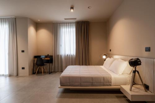 Un dormitorio con una cama y una cámara en un trípode en Amare Suite & Apartments en Bellaria-Igea Marina