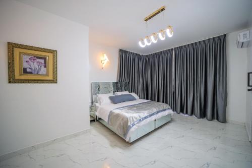 a bedroom with a bed and a large window at El AMO LAKEVIEW VILLA in Entebbe