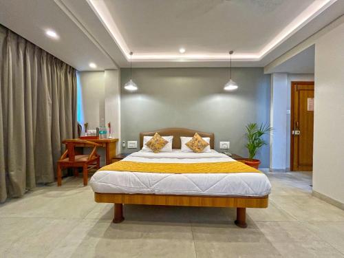 a bedroom with a large bed in a room at Hotel Parklane in Mumbai