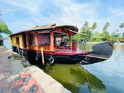 a house boat is docked in the water at Rohini Homestay 3Bhk AC - House boat Available in Alleppey