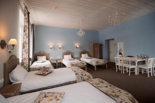 a room with three beds and a table and chairs at Silene Resort & SPA Egles Villa in Silene