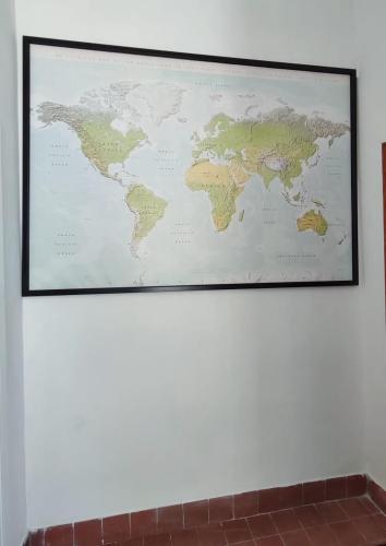 a map of the world hanging on a wall at Confy Apartments Pompei in Pompei