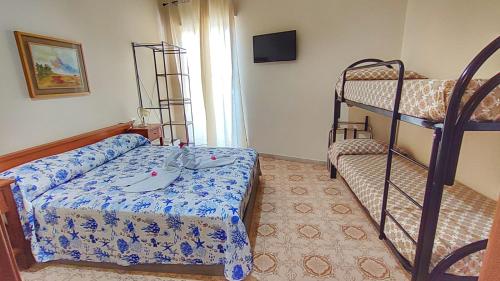 a bedroom with a bed and a bunk bed at Confy Apartments Pompei in Pompei