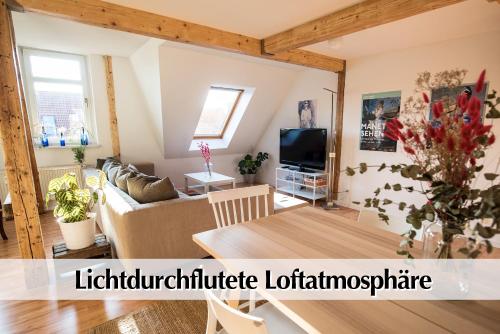 sala de estar con sofá y TV en Helles 80m2 Maisonette-Loft mit Balkon, Kingsize Bett, Smart-TV, etc, en Erfurt
