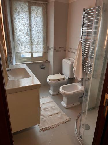 a bathroom with a toilet and a sink and a shower at Casa Diana in Scilla