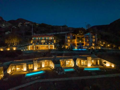 a large house with lights on at night at Chalet Azanias in Kalavrita