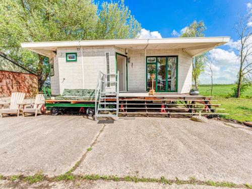 ein kleines weißes, winziges Haus mit einer Veranda in der Unterkunft Secluded Chalet in Suwald with Hottub in Warstiens