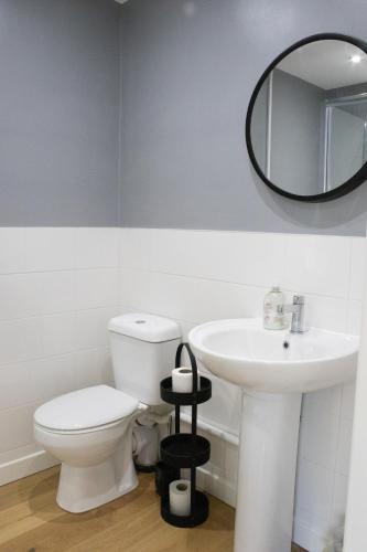 a bathroom with a white toilet and a sink at The Live and Let Live in Downham Market