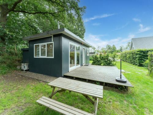a tiny house sitting on top of a lush green yard at Comfortable holiday home in Den Ham with garden in Den Ham