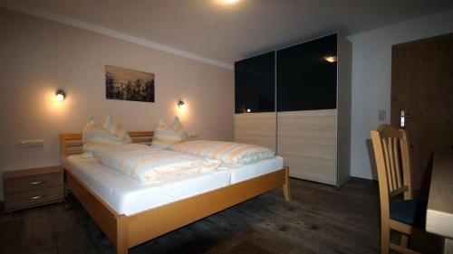 a bedroom with a bed with pillows on it at Haus Bürgler in Dienten am Hochkönig