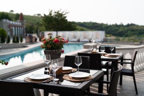 a set of tables with wine glasses on a patio at Sobor Family Resort in Stavcheny