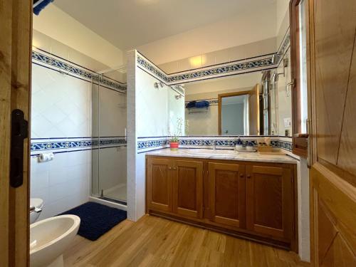 a bathroom with two sinks and a shower at Villa Anastasia in Cugnana