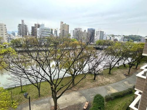a view of a city with a river and buildings at COCOSTAY銀山町リバーサイド,COCOSTAY Kanayamacho riverside, Great location river view-5 min walk from the nearest station in Hiroshima