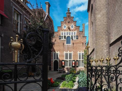 a gate in front of a building with a clock tower at Spacious holiday home in Enkhuizen with terrace in Enkhuizen