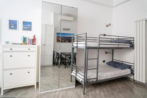 a bedroom with two bunk beds and a table at HouseInGenoaCenter2 Parking in Genova