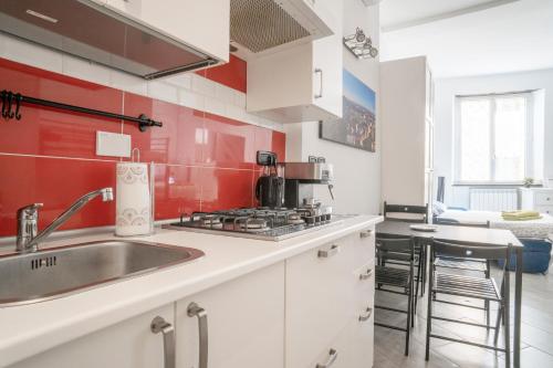 a kitchen with a sink and a stove at HouseInGenoaCenter2 Parking in Genova