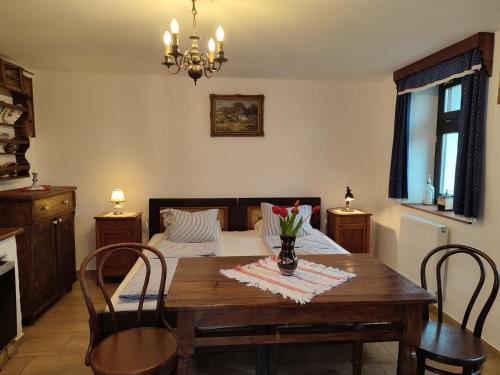 a dining room with a table and a bed at Szent Iván Vendégház in Tata