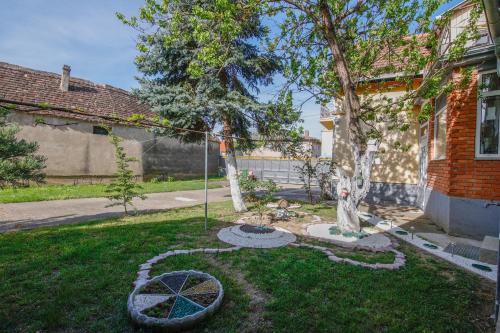 a yard with a tree and a swing at Apartman Marta i soba Maja in Gradište
