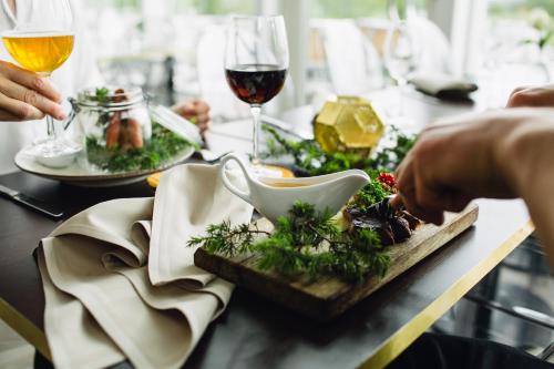 a table with a plate of food and two glasses of wine at Bauergården in Gränna