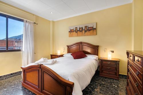 Un dormitorio con una cama grande y una ventana en Cal Guerrer, en Moixent (Mogente)