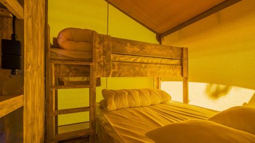 a bedroom with two bunk beds and a ladder at Village Seasonova Bassin d'Arcachon in Audenge