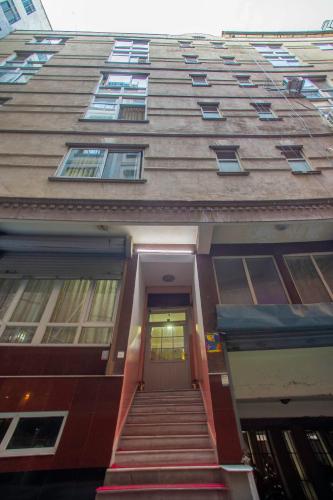 a tall building with stairs leading up to a door at OYO 810 Hotel Peace Golden in Kathmandu