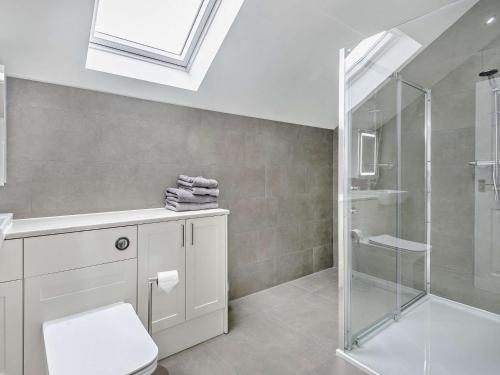 a bathroom with a shower and a toilet and a sink at 4 Bed in Branston 94516 in Branston