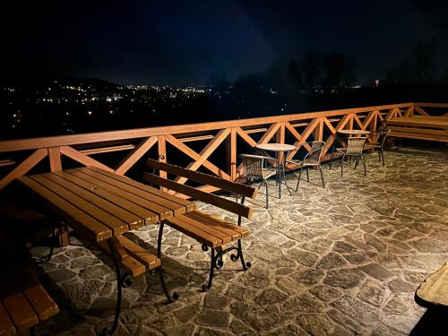 a row of tables and chairs on a patio at night at Mileżówka - Noclegi&SPA in Ustroń