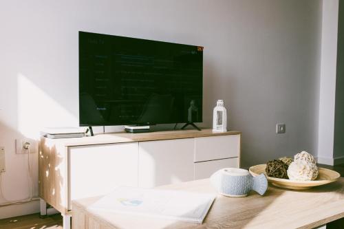 a living room with a tv on a white entertainment center at VV La Niña - Salinetas -Telde in Las Palmas de Gran Canaria