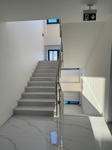 a staircase in a building with a reflection in the water at Mayor Pension in Komárno