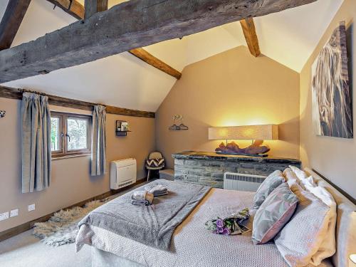 a bedroom with a large bed and a fireplace at 2 Bed in Bidford-on-Avon 94331 in Temple Grafton