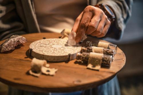 a person cutting a piece of wood on a table at HOTEL StDaniel in Štanjel