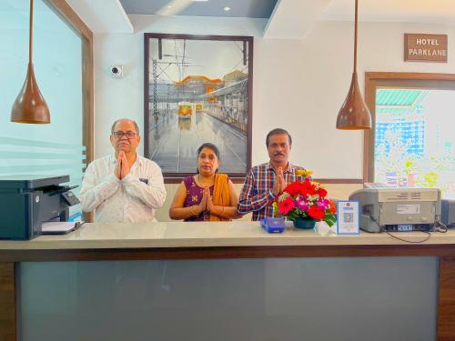 a group of three people sitting at a counter at Hotel Parklane in Mumbai
