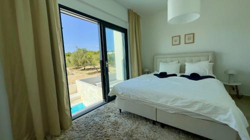 a bedroom with a bed and a large window at Lemon Navy house in Vodice