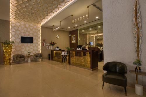 a lobby of a salon with a chair and a counter at Swiss-Belinn Doha in Doha